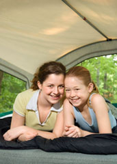 Two girls lying in a tent.