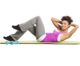 young woman doing stomach crunch on a mat