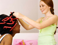 Girl wearing hair curlers.