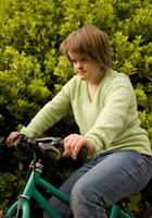 Girls with down-syndrome riding a bike.