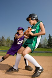 Two girls playing softball.