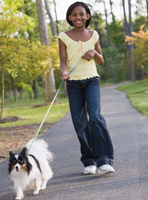 Girl walking her dog.