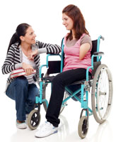 Women talking to a girl in a wheelchair.