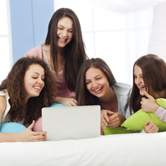 Girls looking at a laptop together