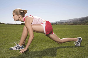 A girl doing a runner's stretch