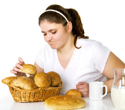 Photo of a teenage girl deciding what to eat.
