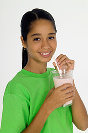 Photo of a girl drinking a protein shake.