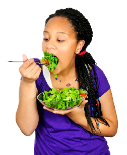 Photo of a girl eating salad.