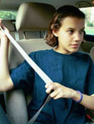 Girl putting on her seatbelt.