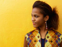 A girl wearing a colorful vest.